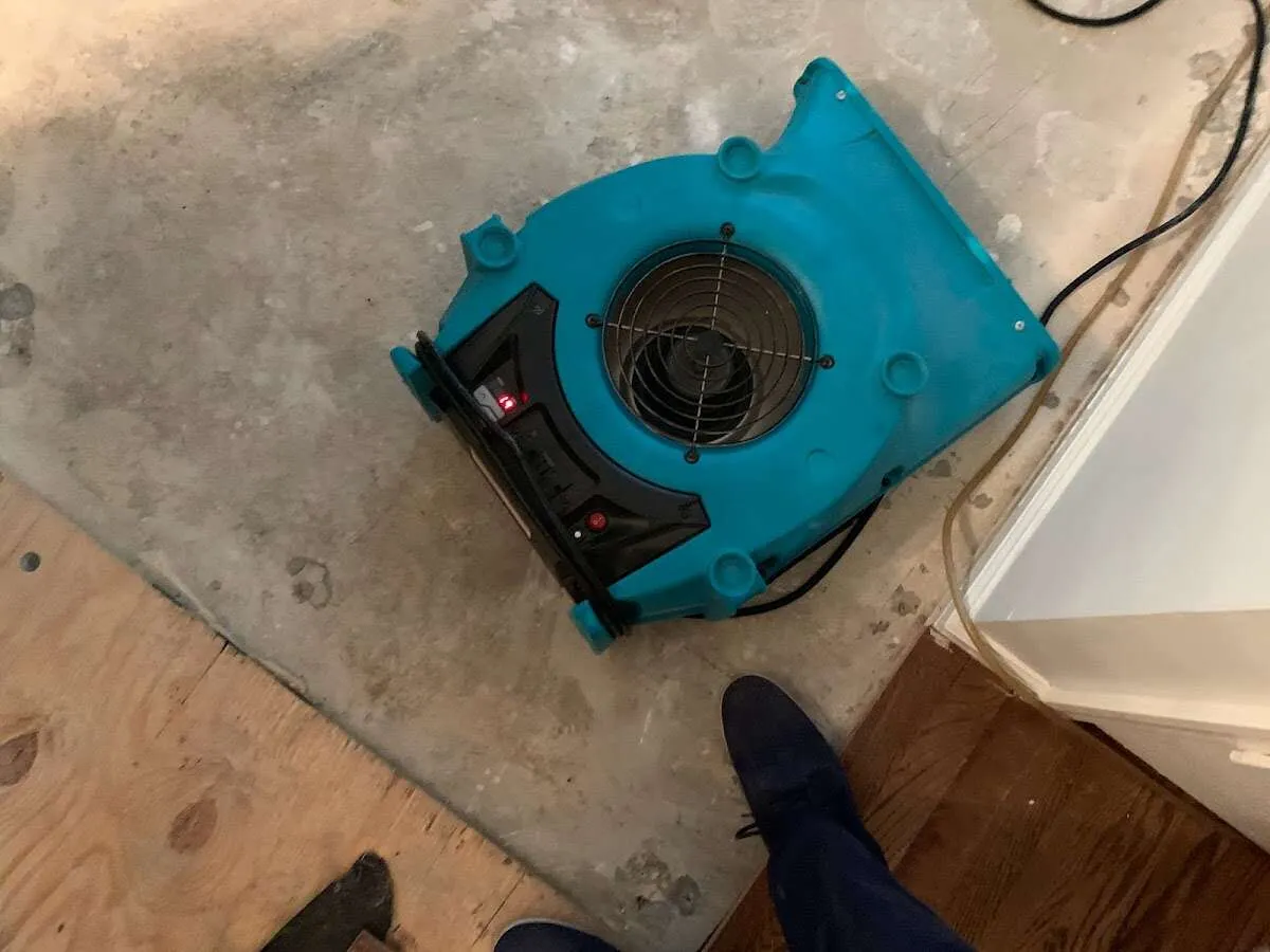 Air mover drying subfloor during Leak Detection & Repair in Kiryas Joel